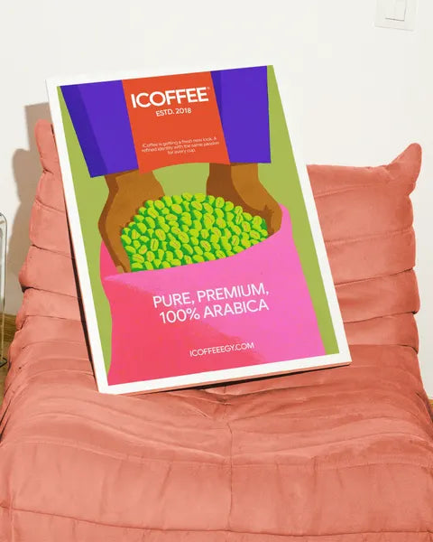ICOFFEE poster on a pink armchair: pure, premium, 100% Arabica